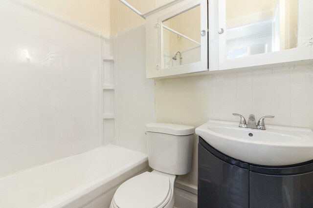 bathroom with vanity,  shower combination, and toilet