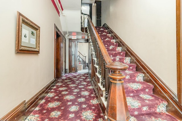 stairway with carpet flooring and baseboards