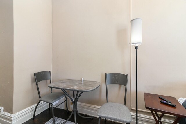 dining area with wood finished floors and baseboards