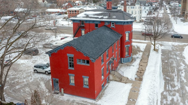 snowy aerial view with a residential view