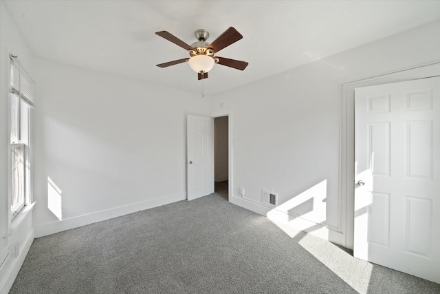 unfurnished bedroom with visible vents, baseboards, carpet, and a ceiling fan