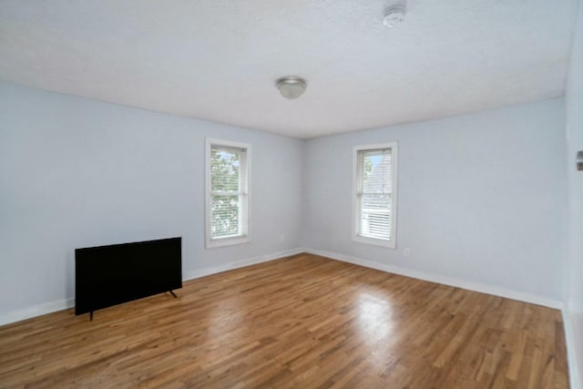 interior space with baseboards and wood finished floors