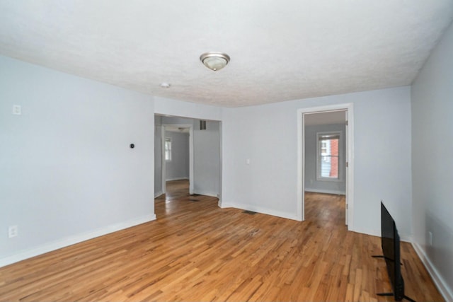 spare room with light wood-style flooring and baseboards