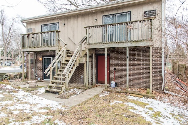 view of front of property featuring stairway and brick siding