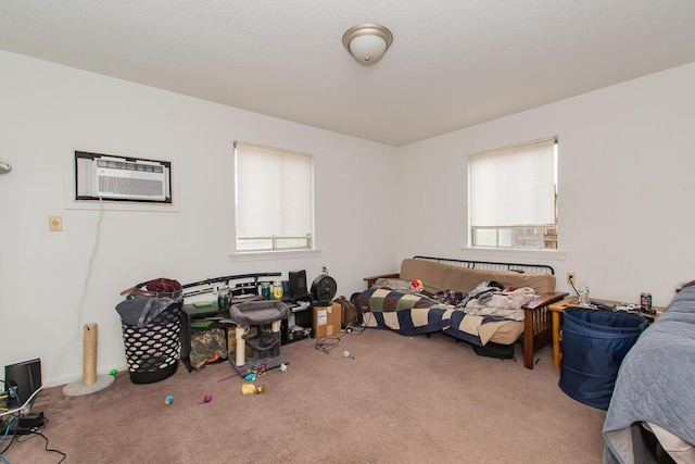 bedroom featuring carpet flooring and an AC wall unit