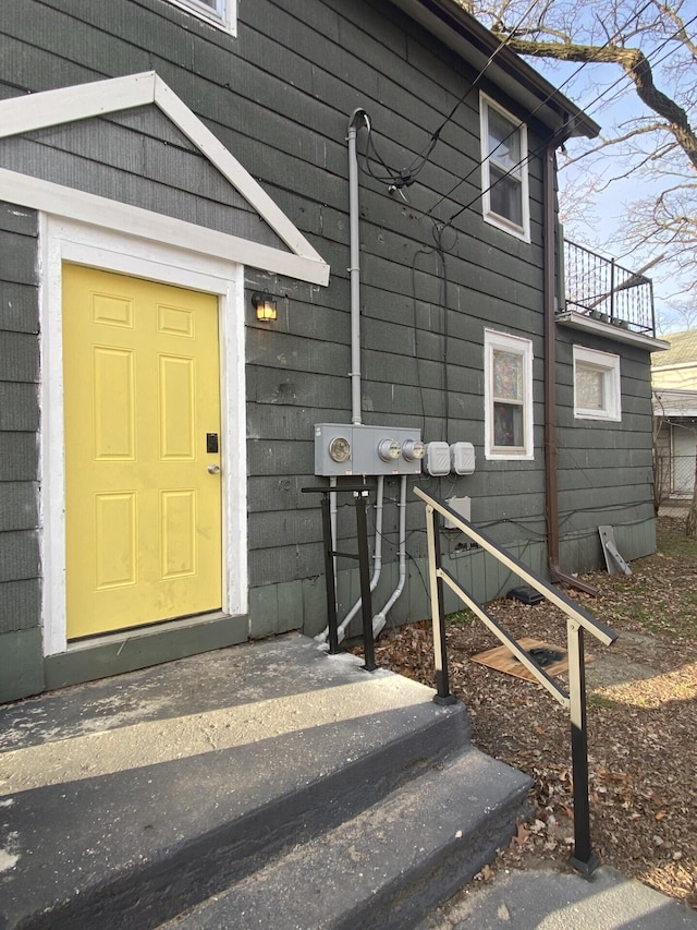 view of exterior entry featuring a balcony