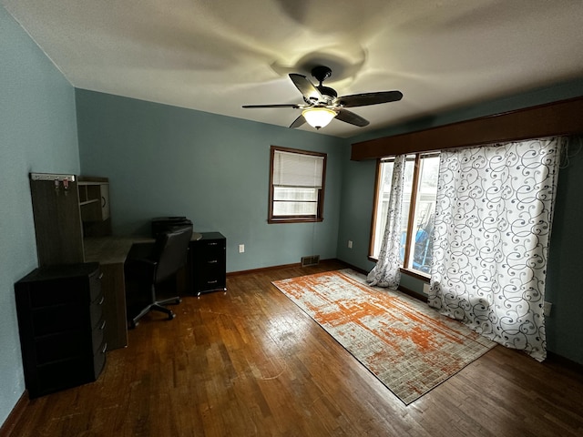 office featuring visible vents, baseboards, ceiling fan, and wood finished floors