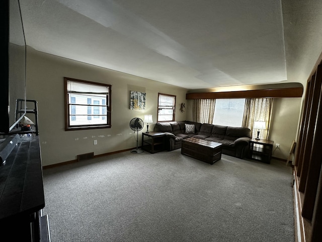 carpeted living area with visible vents and baseboards