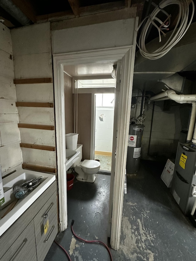 unfinished basement featuring stairway and electric water heater