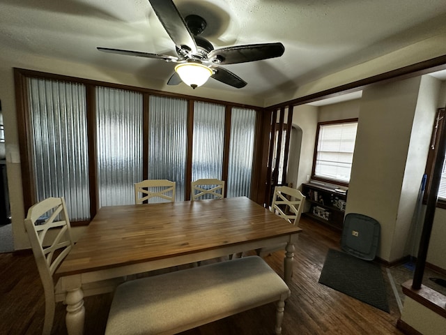 dining area with dark wood finished floors and a ceiling fan