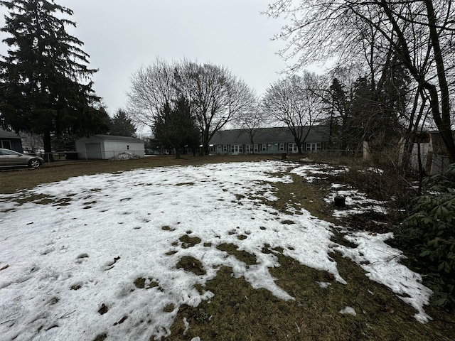 yard covered in snow with fence