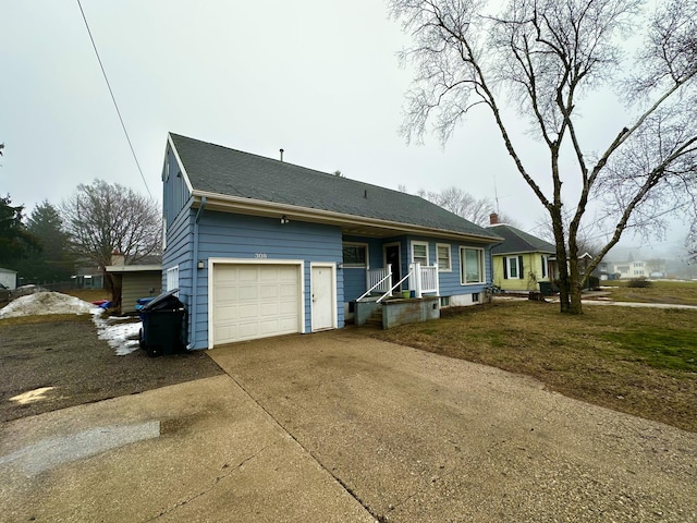 ranch-style home featuring driveway, an attached garage, and roof with shingles