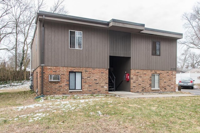 view of front of property with a front yard and brick siding