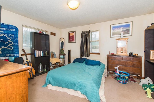 bedroom featuring carpet and a textured ceiling