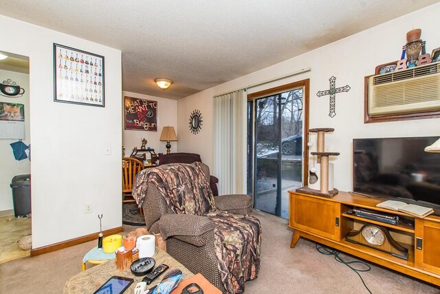 living area featuring baseboards, light carpet, and a textured ceiling