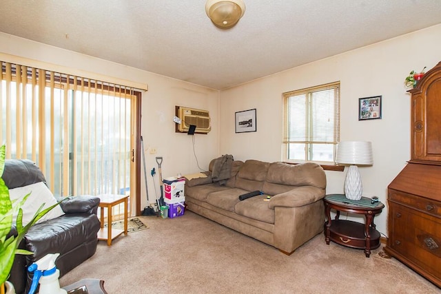 living room featuring a textured ceiling, an AC wall unit, and light carpet