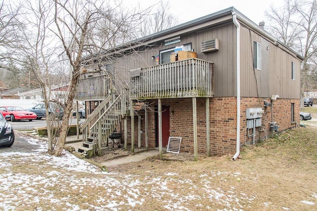 townhome / multi-family property with brick siding and stairway