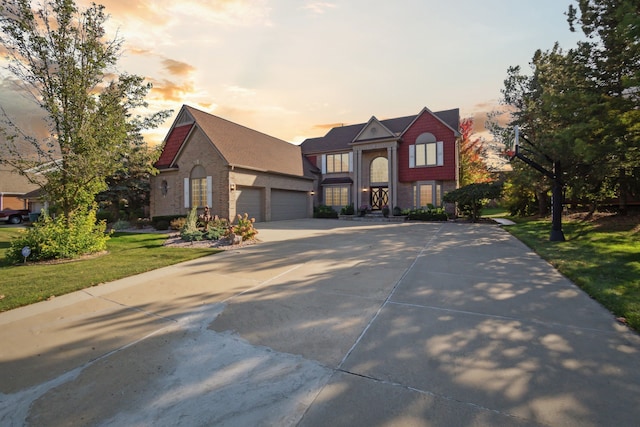 view of front of house featuring driveway, a front lawn, and a garage