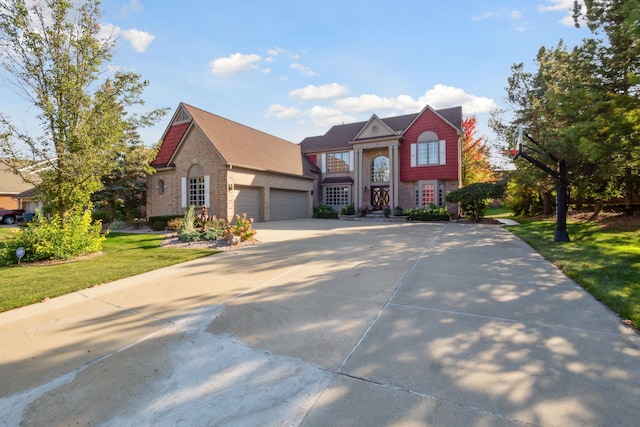 view of front of property with a garage, brick siding, concrete driveway, and a front yard