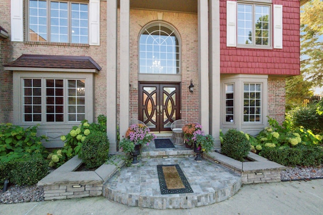 view of exterior entry featuring brick siding