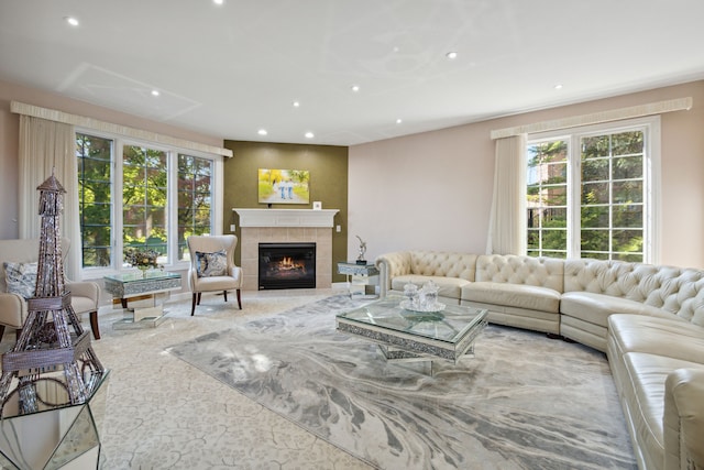 living room featuring a wealth of natural light, recessed lighting, and a tiled fireplace