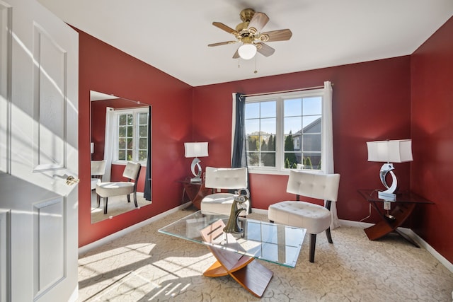 sitting room with carpet flooring, baseboards, and ceiling fan