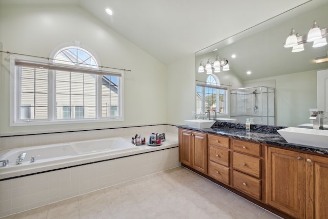 full bath with a sink, a garden tub, double vanity, and a shower stall