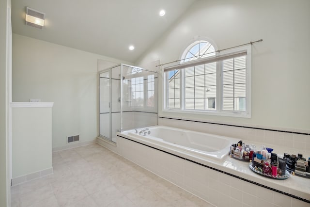 bathroom with a bath, visible vents, and a stall shower