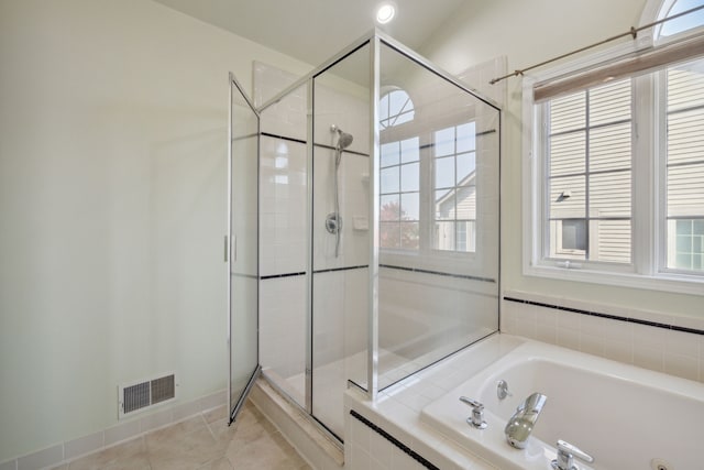 full bathroom with tile patterned floors, a garden tub, a healthy amount of sunlight, and a shower stall