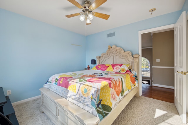 bedroom featuring baseboards, visible vents, and ceiling fan