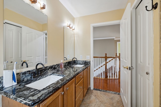 bathroom with a sink and double vanity