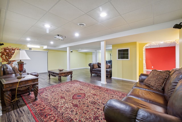 living area with visible vents, baseboards, and wood finished floors