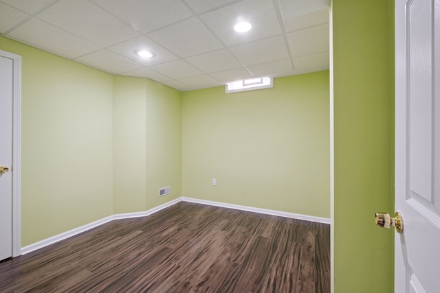 unfurnished room featuring visible vents, dark wood-style floors, recessed lighting, baseboards, and a paneled ceiling