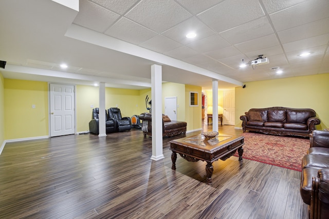 living room with recessed lighting, a paneled ceiling, baseboards, and wood finished floors