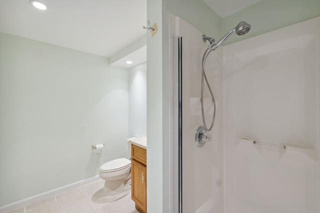 full bathroom with baseboards, toilet, tile patterned floors, vanity, and a shower