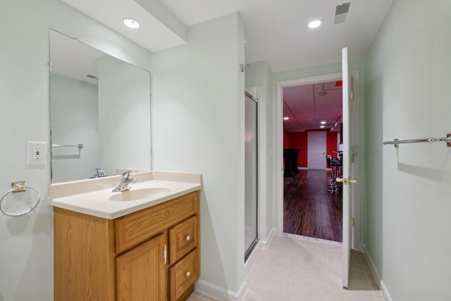 full bath with vanity, visible vents, a stall shower, and tile patterned flooring