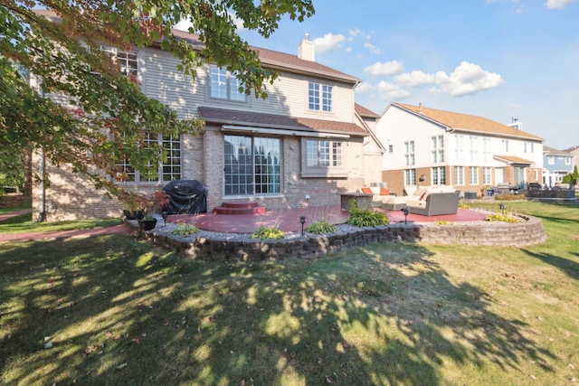 rear view of house featuring brick siding, a lawn, a chimney, outdoor lounge area, and a patio