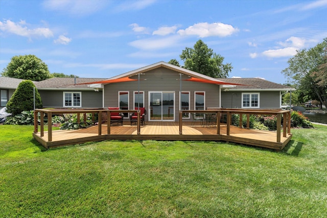 rear view of house featuring a lawn