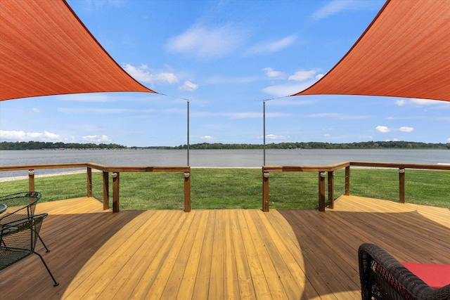 view of dock with a yard and a deck with water view