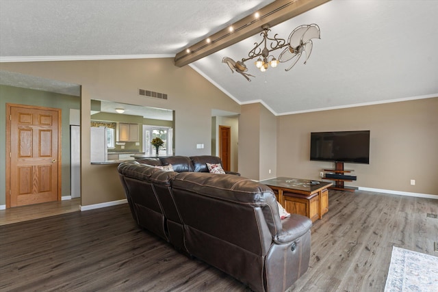 living room featuring visible vents, wood finished floors, baseboards, and vaulted ceiling