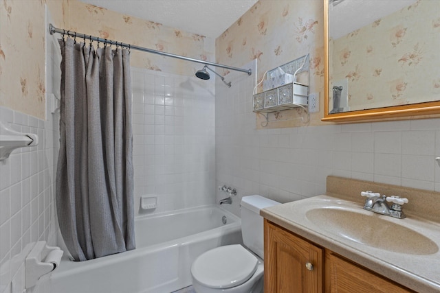 full bathroom with a wainscoted wall, a textured ceiling, wallpapered walls, and shower / bath combo