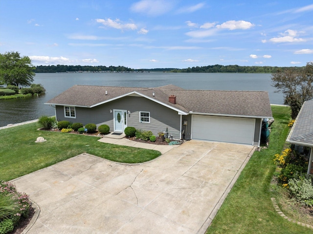 single story home featuring a garage, driveway, a front lawn, and a water view