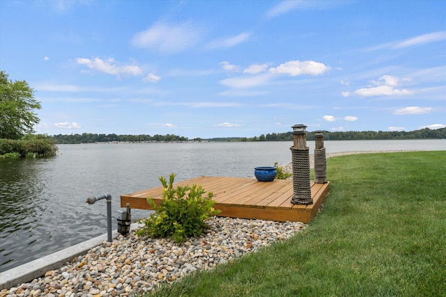 dock area featuring a lawn and a water view