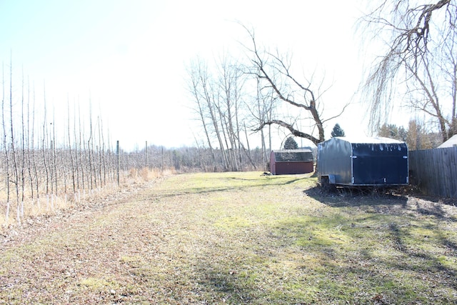 view of yard featuring a rural view and fence