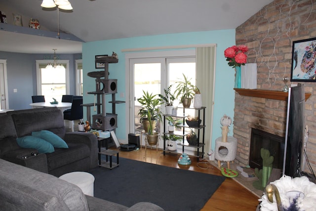 living room with plenty of natural light, lofted ceiling, and wood finished floors