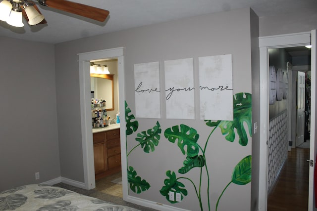 bedroom featuring ceiling fan and connected bathroom