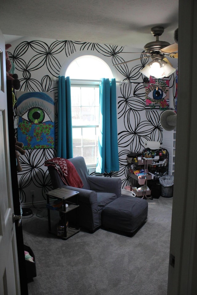 sitting room featuring carpet flooring and a ceiling fan