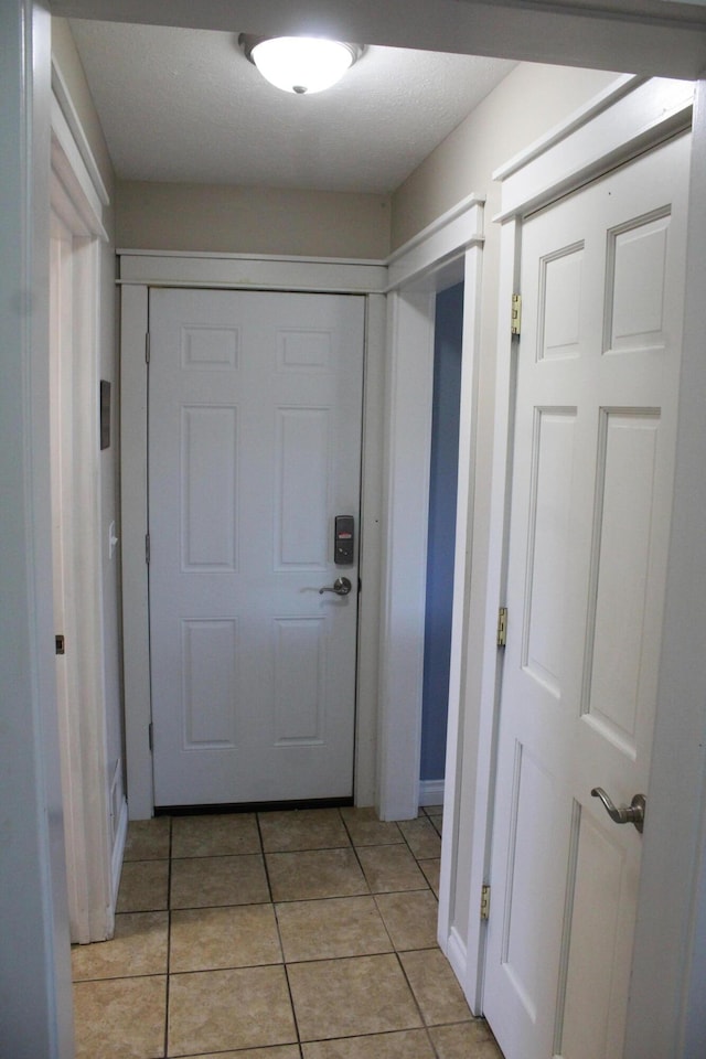 doorway to outside featuring light tile patterned floors