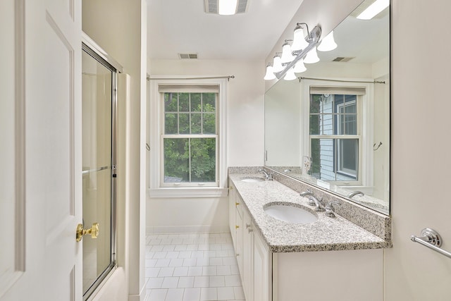 bathroom featuring tile patterned floors, visible vents, and a sink