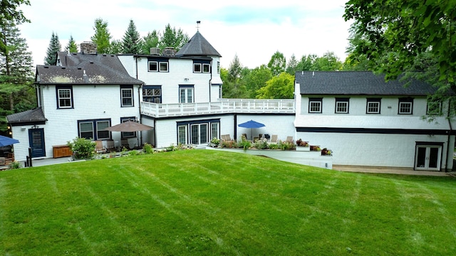 back of property featuring a lawn, french doors, and a chimney